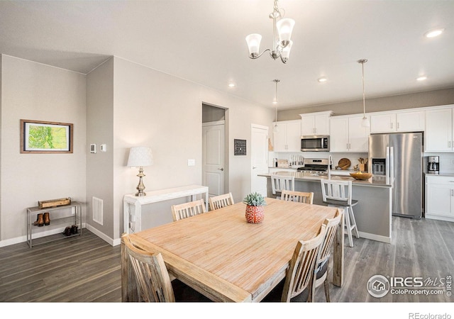 dining area featuring recessed lighting, baseboards, and wood finished floors