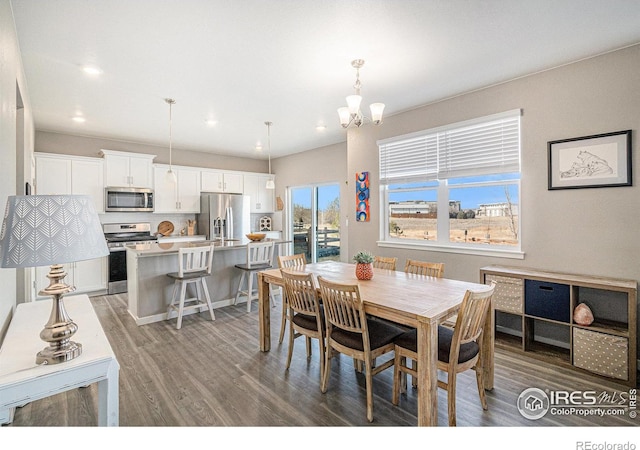 dining room featuring light wood-style flooring, a notable chandelier, and recessed lighting