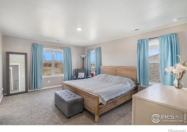 bedroom with baseboards, visible vents, and carpet floors