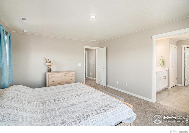 carpeted bedroom with visible vents and baseboards