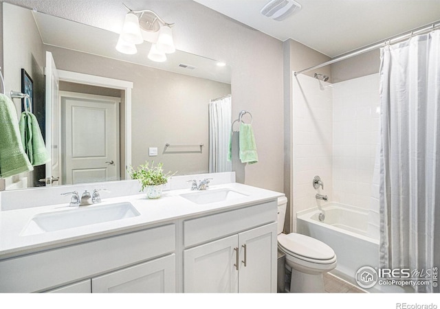 full bath with double vanity, toilet, visible vents, and a sink