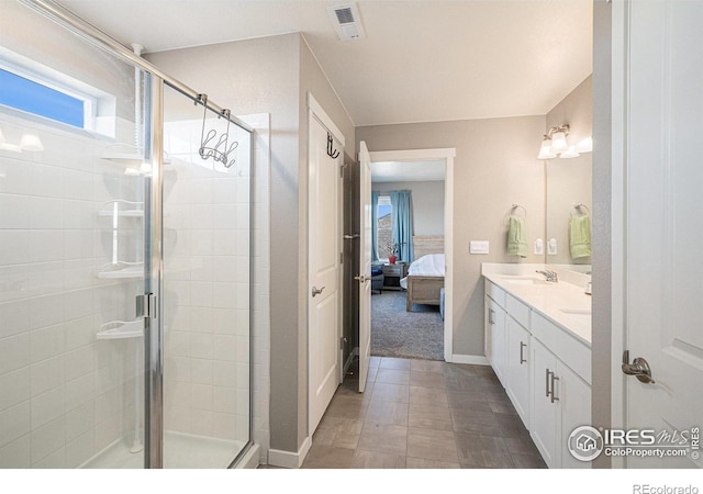 full bathroom with a sink, visible vents, connected bathroom, and a stall shower