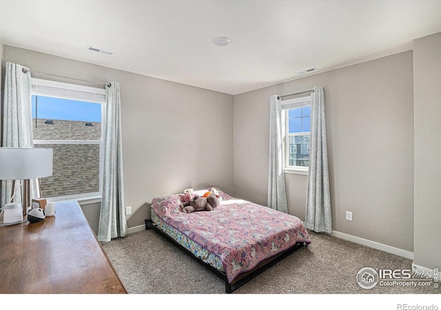 bedroom with visible vents, baseboards, and carpet