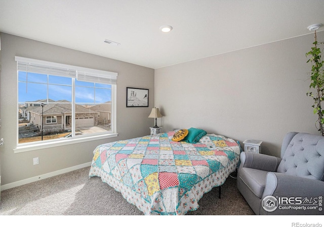 carpeted bedroom with visible vents and baseboards