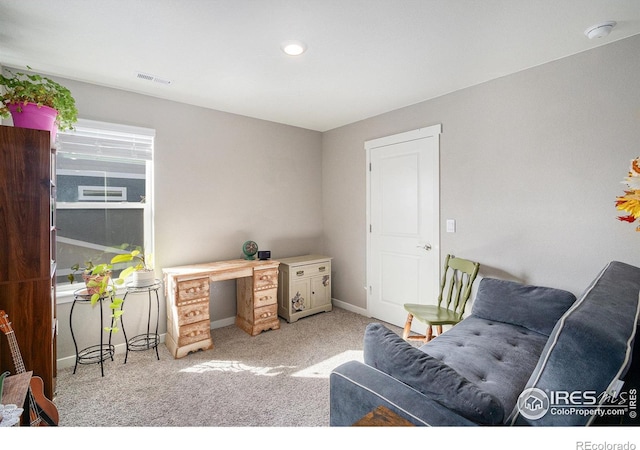 home office featuring light carpet, visible vents, and baseboards