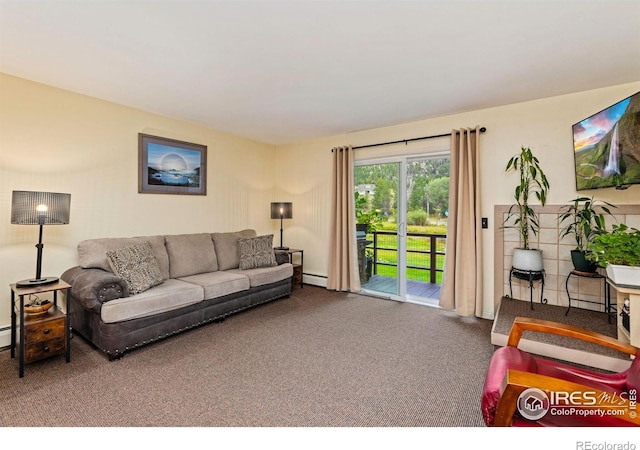 living room with a baseboard heating unit and carpet flooring