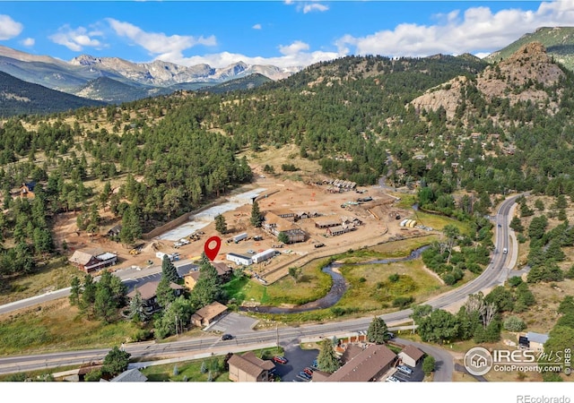 aerial view featuring a mountain view and a view of trees