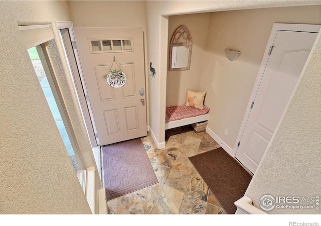 foyer entrance with baseboards