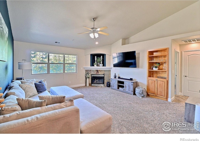 carpeted living room featuring visible vents, baseboards, a fireplace, ceiling fan, and vaulted ceiling