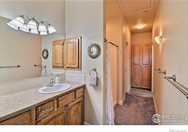 bathroom featuring baseboards and vanity