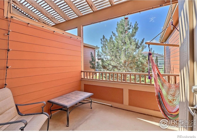 balcony featuring a pergola