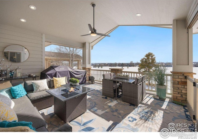 view of patio with an outdoor living space with a fire pit, outdoor dining area, and ceiling fan