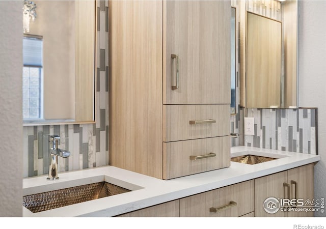 bathroom with tasteful backsplash and a sink