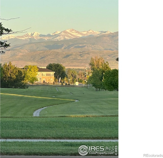 view of home's community with a lawn and a mountain view