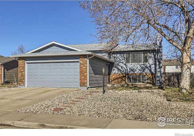 view of front of property featuring brick siding, concrete driveway, an attached garage, and fence