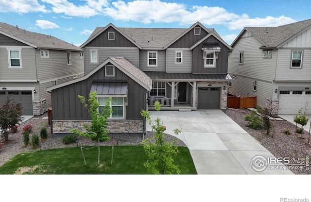 890 Meadowlark Dr, Erie, CO 80516 - craftsman house featuring driveway, a standing seam roof, a garage, stone siding, and board and batten siding