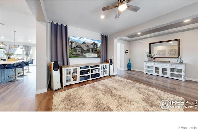 living room featuring recessed lighting, wood finished floors, baseboards, and ceiling fan