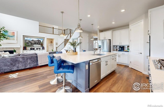 890 Meadowlark Dr, Erie, CO 80516 - kitchen with a sink, stainless steel appliances, open floor plan, and white cabinets