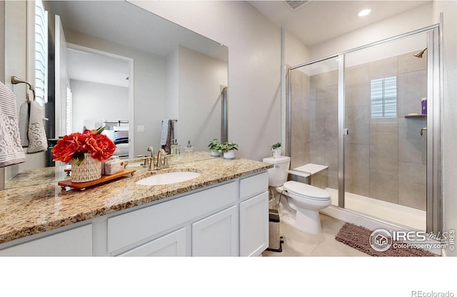 890 Meadowlark Dr, Erie, CO 80516 - full bath featuring vanity, toilet, a stall shower, and tile patterned flooring