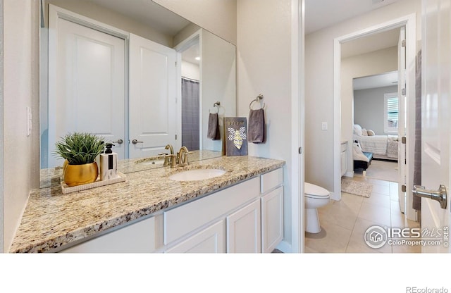 890 Meadowlark Dr, Erie, CO 80516 - bathroom with tile patterned flooring, toilet, and vanity