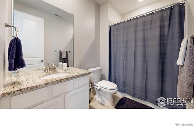 890 Meadowlark Dr, Erie, CO 80516 - full bathroom with vanity, toilet, visible vents, and tile patterned flooring
