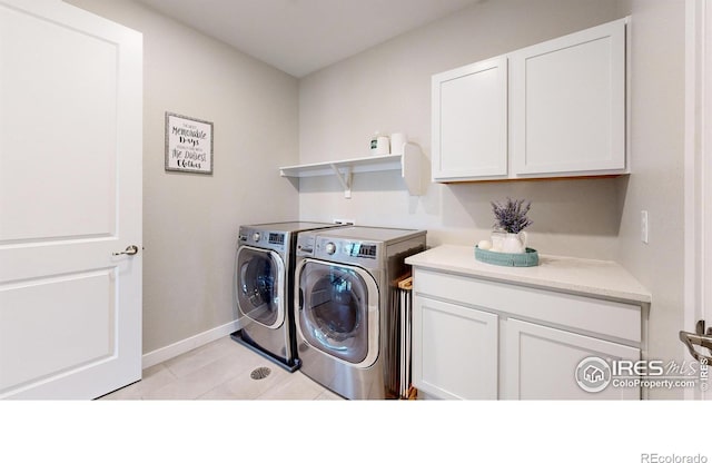 890 Meadowlark Dr, Erie, CO 80516 - clothes washing area featuring cabinet space, light tile patterned flooring, washing machine and dryer, and baseboards