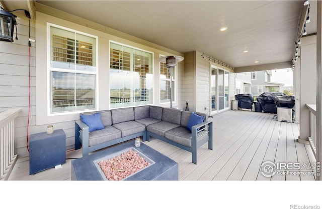 890 Meadowlark Dr, Erie, CO 80516 - wooden deck featuring an outdoor living space with a fire pit and a grill