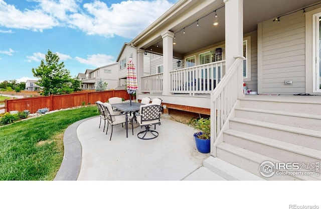 890 Meadowlark Dr, Erie, CO 80516 - view of patio featuring outdoor dining space and fence