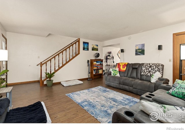 living room with stairway, baseboards, and wood finished floors