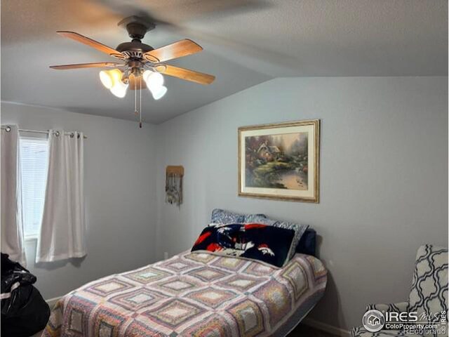 bedroom with lofted ceiling and a ceiling fan