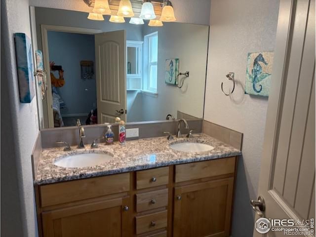 full bathroom with a sink and double vanity