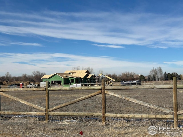 view of gate with a rural view and fence