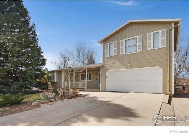 view of front of house with a porch, an attached garage, and driveway