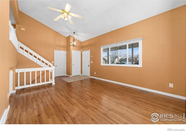 entryway with visible vents, a ceiling fan, wood finished floors, stairway, and baseboards