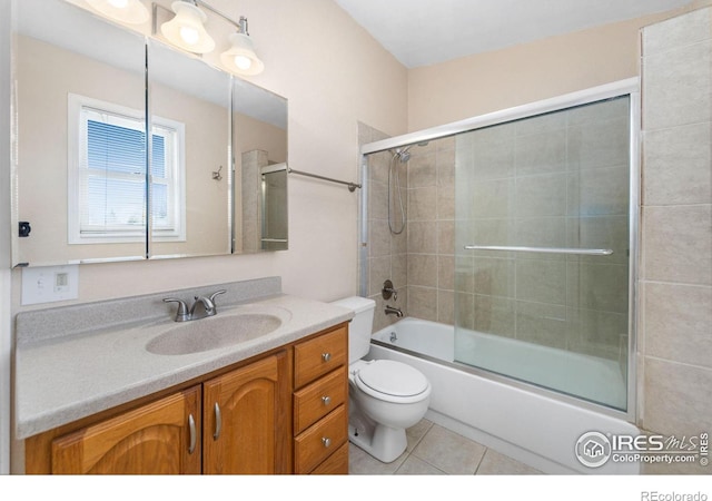 full bathroom with enclosed tub / shower combo, toilet, vanity, and tile patterned flooring