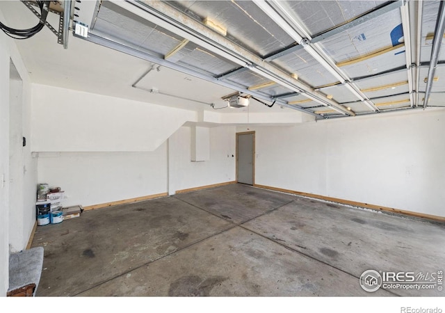 garage featuring a garage door opener and baseboards