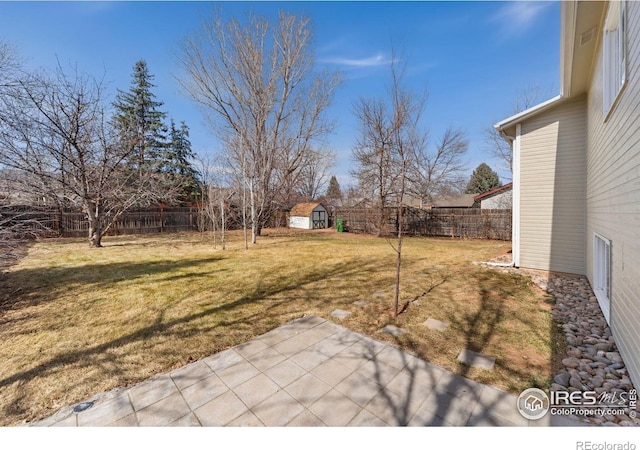 view of yard featuring a storage shed, an outdoor structure, a fenced backyard, and a patio