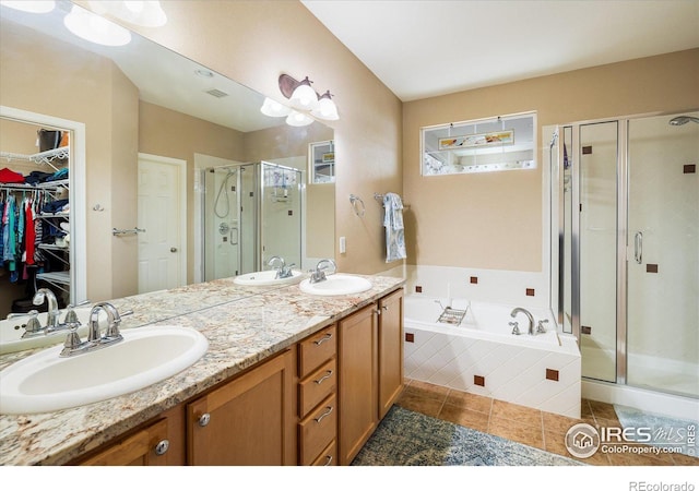 bathroom with a shower stall, a garden tub, and a sink