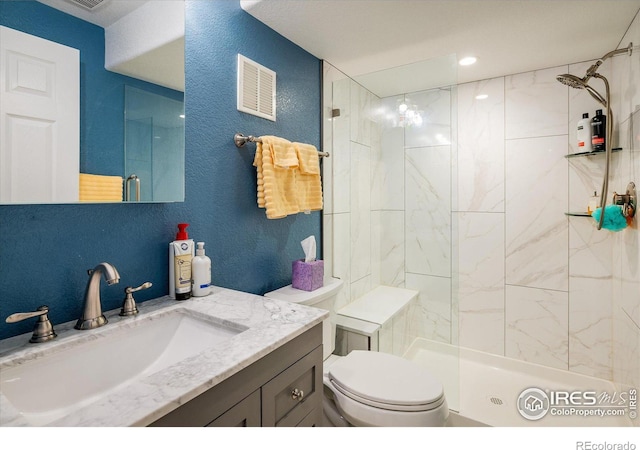 full bath featuring visible vents, a stall shower, toilet, and a textured wall