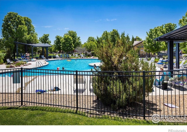 pool featuring a patio and fence