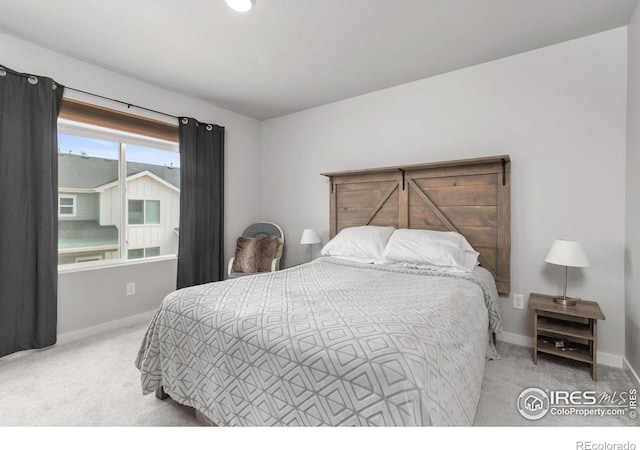 bedroom with carpet flooring and baseboards