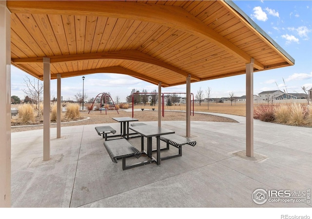 view of property's community with a patio and playground community