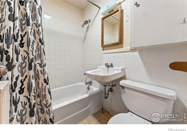 full bath featuring shower / bath combo with shower curtain, radiator, toilet, and tile walls