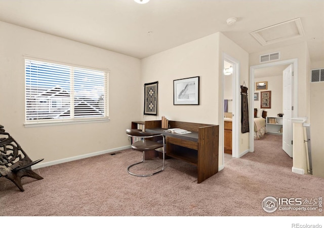 home office with visible vents, baseboards, attic access, and carpet flooring