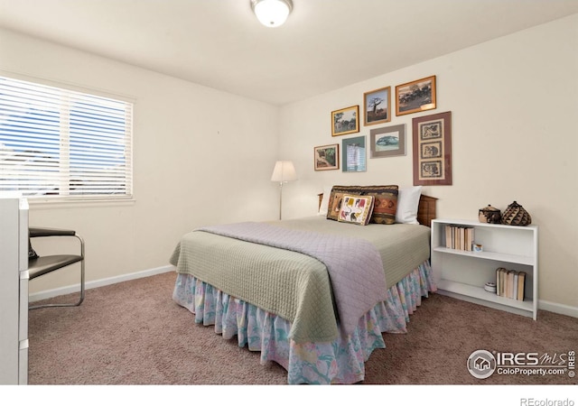 carpeted bedroom featuring baseboards