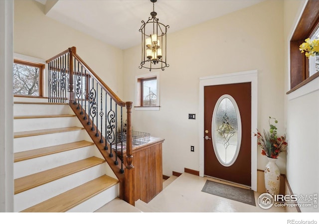 foyer entrance featuring a chandelier and stairs