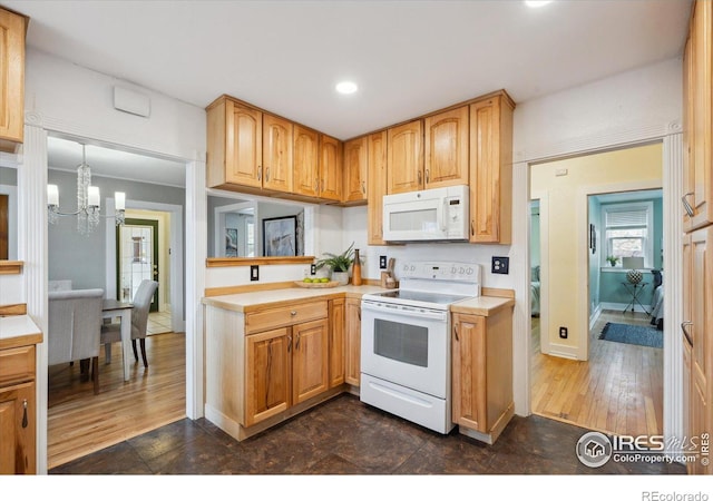 kitchen with a chandelier, light countertops, recessed lighting, white appliances, and dark wood-style flooring