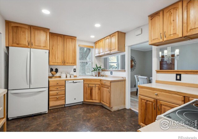 kitchen featuring recessed lighting, white appliances, an inviting chandelier, and light countertops