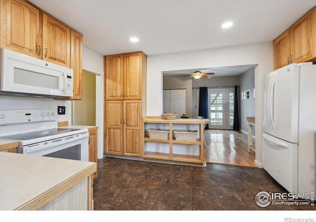 kitchen featuring recessed lighting, baseboards, white appliances, and light countertops