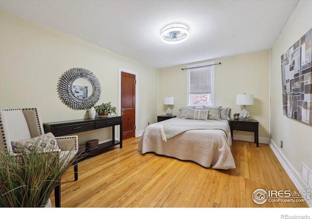 bedroom with wood finished floors and baseboards